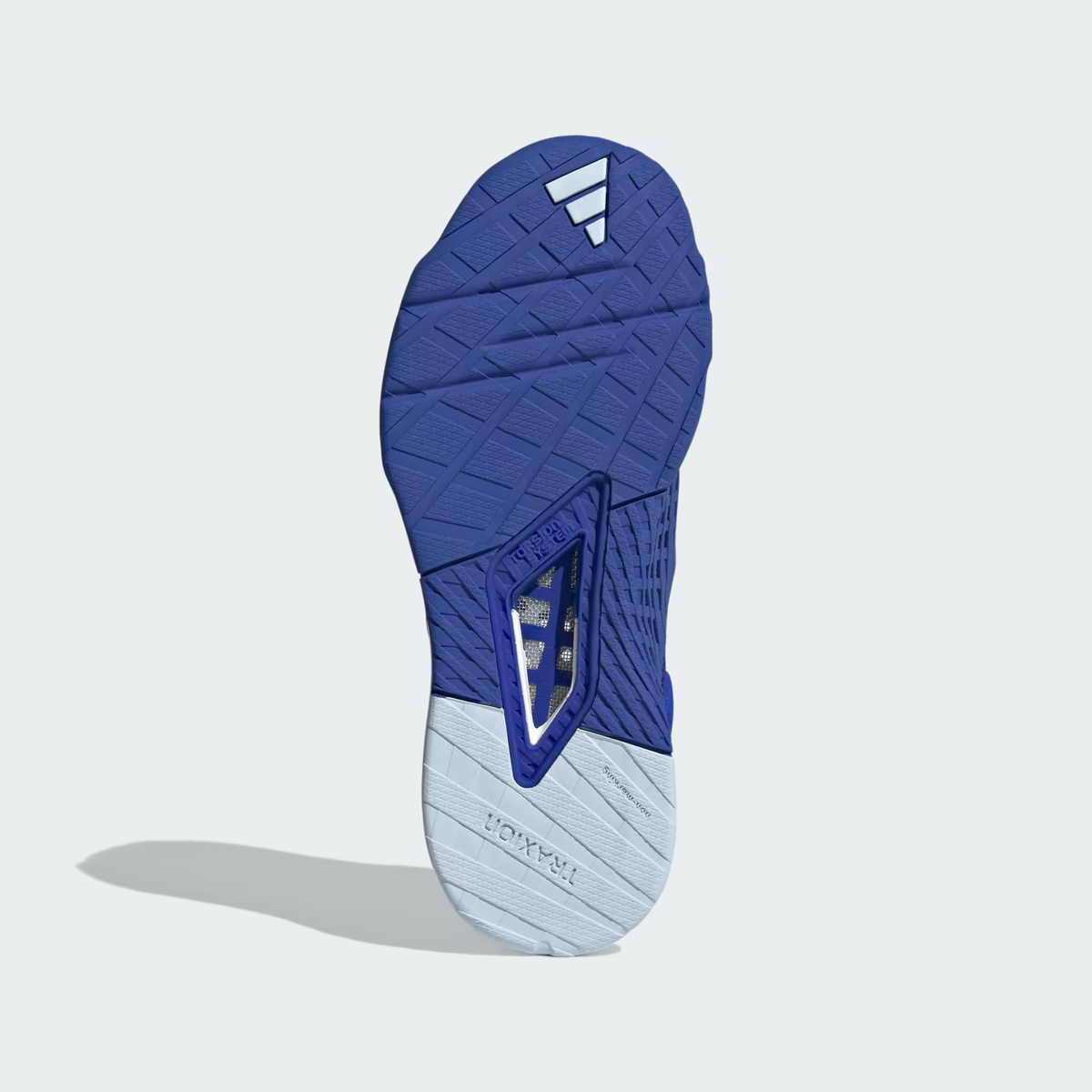 Adidas Dropset 3 ID8636 - Rear 3/4 Shot on Light Grey Background showing Lucid Blue Structured Heel Counter with TRAINING Embossed Text, Blue Spark Metallic Three Stripes on Lateral Quarter Panel, HEAT.RDY Engineered Knit Upper, Chalk White Heel Midsole Wedge & Blue Rubber Outsole