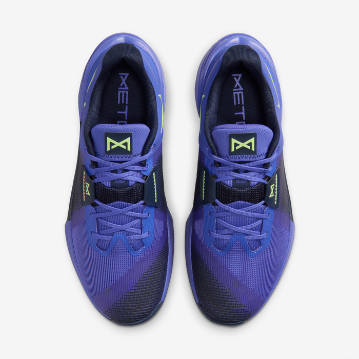 Nike Metcon 10 HJ1875-501 - Rear Pair Shot on White Background showing Persian Violet Upper, Light Lemon Twist Mini Swoosh on Heel Counter, Obsidian Heel Panel, Metcon Text Embossed on Persian Violet Midsole & Obsidian Rubber Outsole
