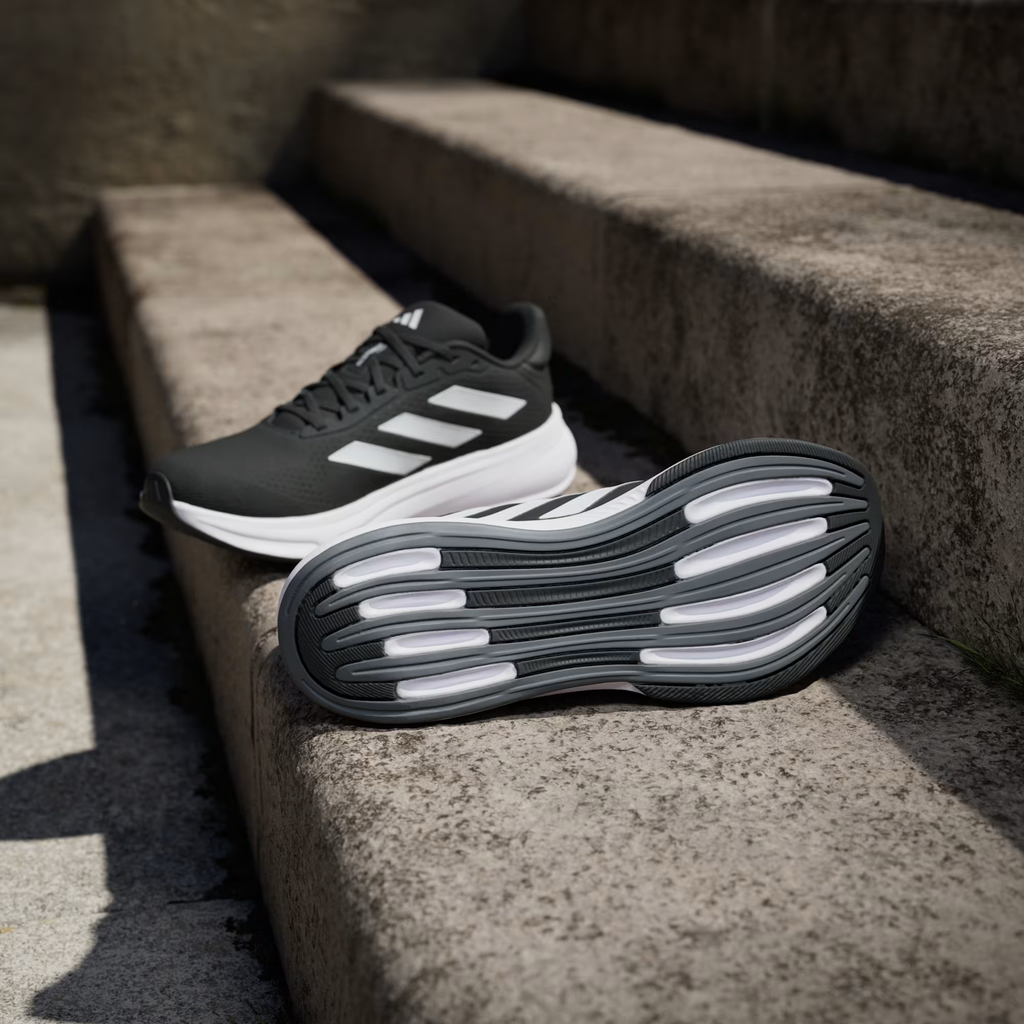 Adidas Response Super JI4308 - Rear Heel Pair Shot on Stone Wall showing White Three Stripes on Lateral, Black Heel Counter & White Response Midsole with Black Outsole