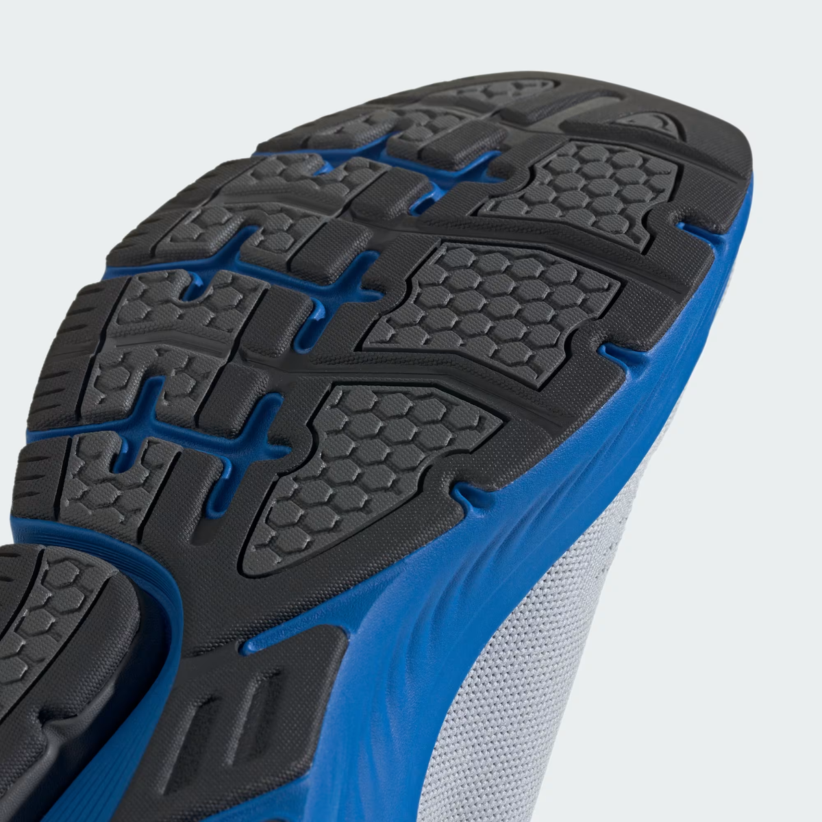 Adidas Cloudfoam Walk Sock ID4065 - Forefoot Outsole Close-up showing Black Segmented Traction Pad Blocks, Honeycomb Micro-Texture on Grip Panels, Flex Groove Channels, Bright Royal Cloudfoam Walk Midsole Sidewall & Halo Silver Knit Upper Edge