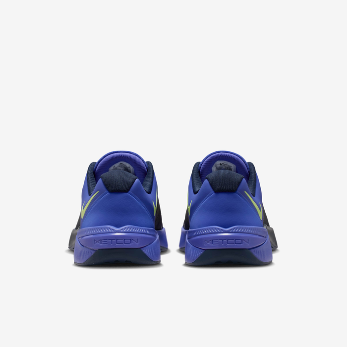 Nike Metcon 10 HJ1875-501 - Heel & Midsole Close-up showing Light Lemon Twist Swoosh on Persian Violet Heel Counter, Metcon Text on Persian Violet Midsole, Obsidian Forefoot Wrap Edge & Diamond-Pattern Obsidian Rubber Outsole