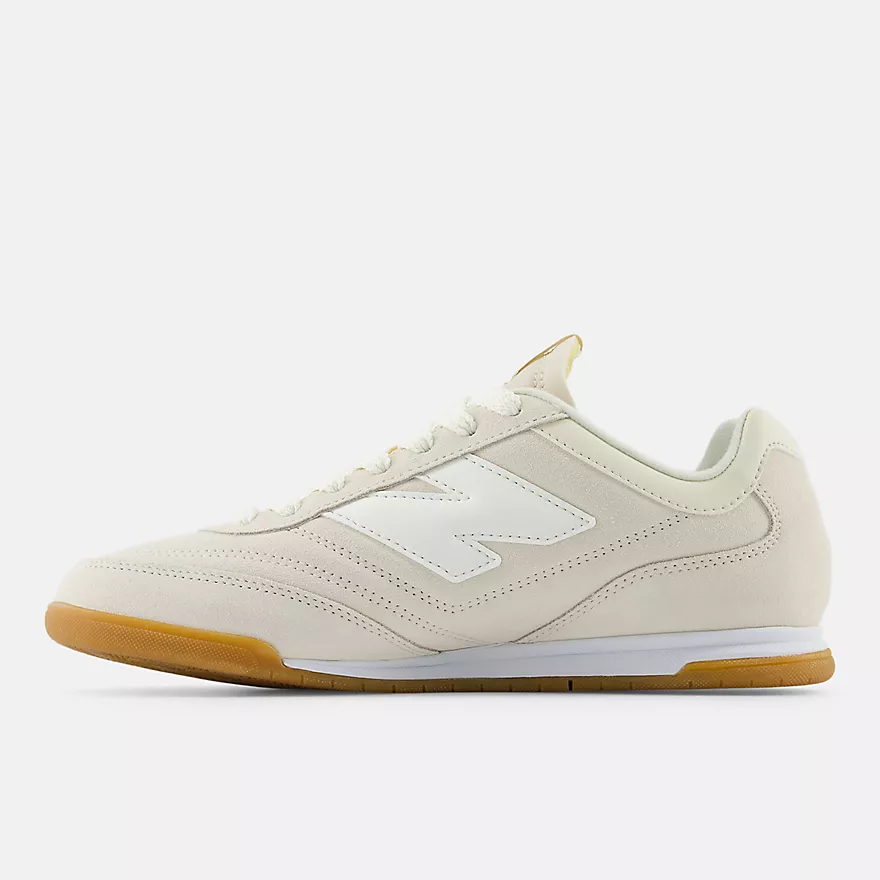 New Balance RC42 URC42EA - Medial Profile on Light Grey Background showing Linen Suede Upper, Perforated Toe Box & Quarter Panel, Sea Salt White NB Logo Medial Side, Cream Collar Lining with Yellow Pull Tab, White Midsole & Amber Gum Indoor Court Outsole