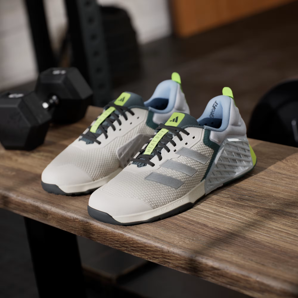 Adidas Dropset 3 JR1762 - Clean Lateral Profile on Gym Floor in Chalk White/Silver Metallic/Preloved Teal showing Mesh Upper, Silver Three Stripes, Teal Heel Counter, Neon Yellow Heel Tab & Dual Density Midsole with Black Outsole