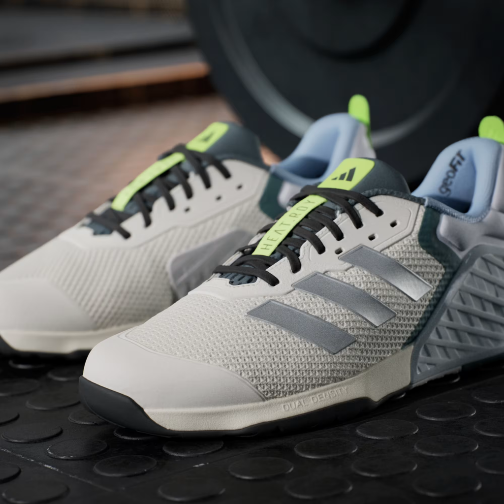 Adidas Dropset 3 JR1762 - Front 3/4 Single Shot with Outsole on Wooden Gym Bench showing HEAT.RDY Lace Dubrae, Silver Three Stripes, Neon Yellow Tongue Tab, geoFit Collar, Dual Density Midsole Text & Black Rubber Outsole