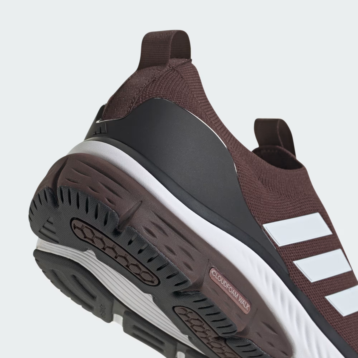 Adidas Cloudfoam Walk Sock ID4063 - Forefoot & Three Stripes Close-up showing Shadow Brown Engineered Knit Dot-Ventilation Pattern on Toe Box, Front Elastic Band Pull Tab, Cloud White Three Stripes Overlay on Lateral Midfoot, Cloud White Cloudfoam Walk Midsole Sidewall & Black Rubber Outsole Edge