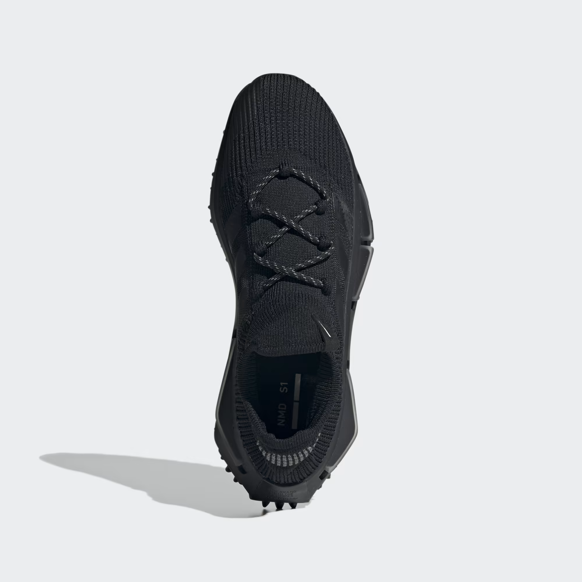 Adidas NMD_S1 FZ6381 - Front 3/4 Shot on White Background in Core Black showing Primeknit Sock Upper, Tonal Black Three Stripes, Reflective Lace Loop, Black Boost Midsole with NMD Plug Detail & Chunky Black Lug Rubber Outsole
