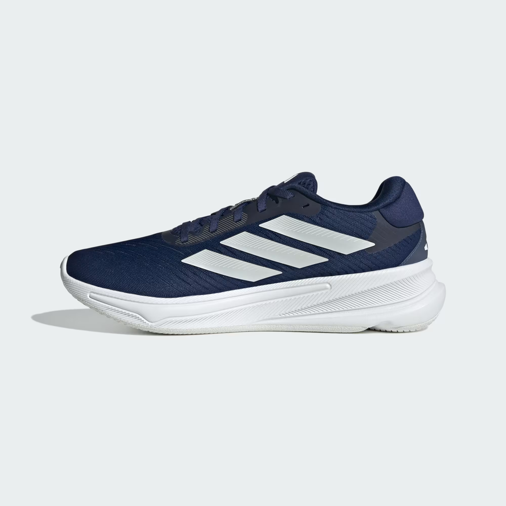Adidas Supernova Ease JH8560 - Lateral Heel & Midsole Close-up showing Dark Blue Engineered Mesh Texture, Zero Metallic Three Stripes Detail, Dark Blue Padded Collar, Supernova Ease Midsole Branding & White Herringbone Outsole Edge