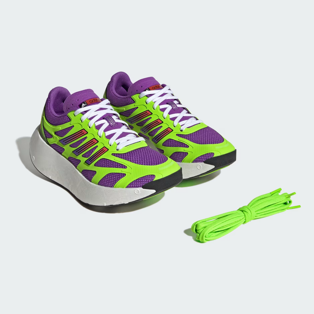 Adidas Adizero Aruku JP5566 - On-Foot Lifestyle Shot on Blue Court Surface showing Active Purple/Solar Green Colourway, Chunky White Swirl-Foam Midsole, Black Outsole & Gradient Three Stripes worn with White Crew Socks