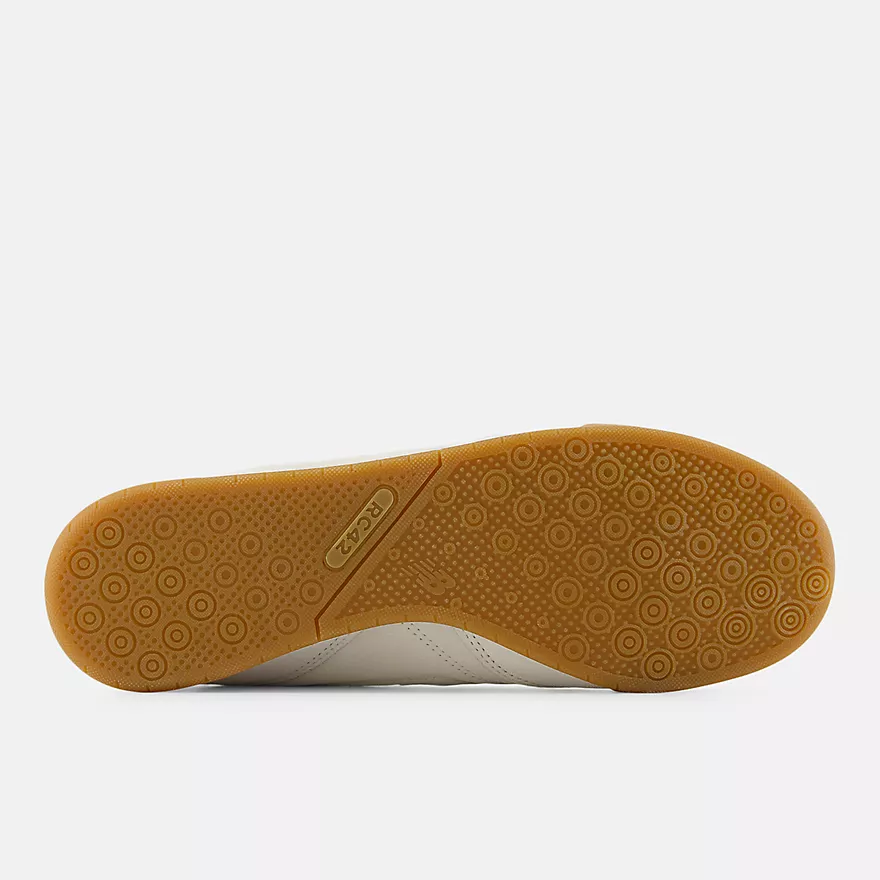 New Balance RC42 URC42EA - Full Amber Gum Rubber Outsole Top-Down showing Concentric Circle Traction Pattern across Full Outsole, RC42 Pill Badge on Lateral Heel, Centre Split Flex Groove & White Midsole Edge