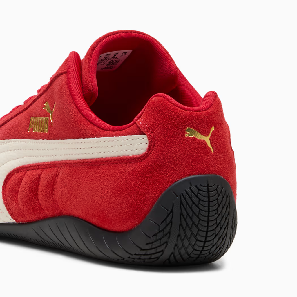 PUMA Speedcat 406329_02 - Heel & Outsole Close-up on White Background showing For All Time Red Premium Suede Texture, PUMA White Leather Formstripe, Gold PUMA Cat Logo on Heel Quarter Panel, Red Padded Collar & Black Tyre-Tread Rubber Outsole