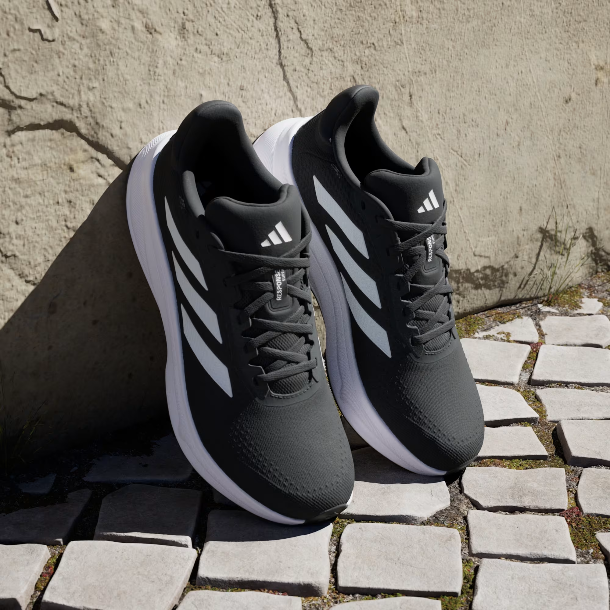 Adidas Response Super JI4308 - Clean Lateral Profile on Cobblestone in Core Black/Cloud White showing Full Silhouette, White Three Stripes & Chunky White Response Midsole