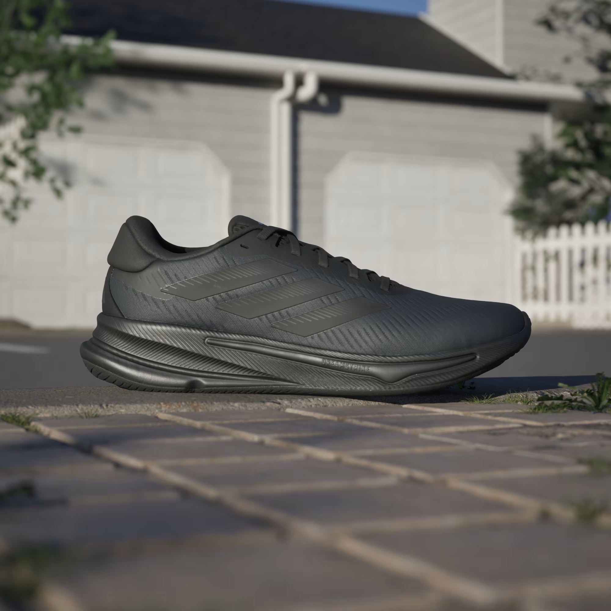 Adidas Supernova Ease IH2580 - Front 3/4 Pair Shot on Cobblestone in Core Black/Core Black/Carbon showing Tonal Three Stripes & Engineered Mesh Upper