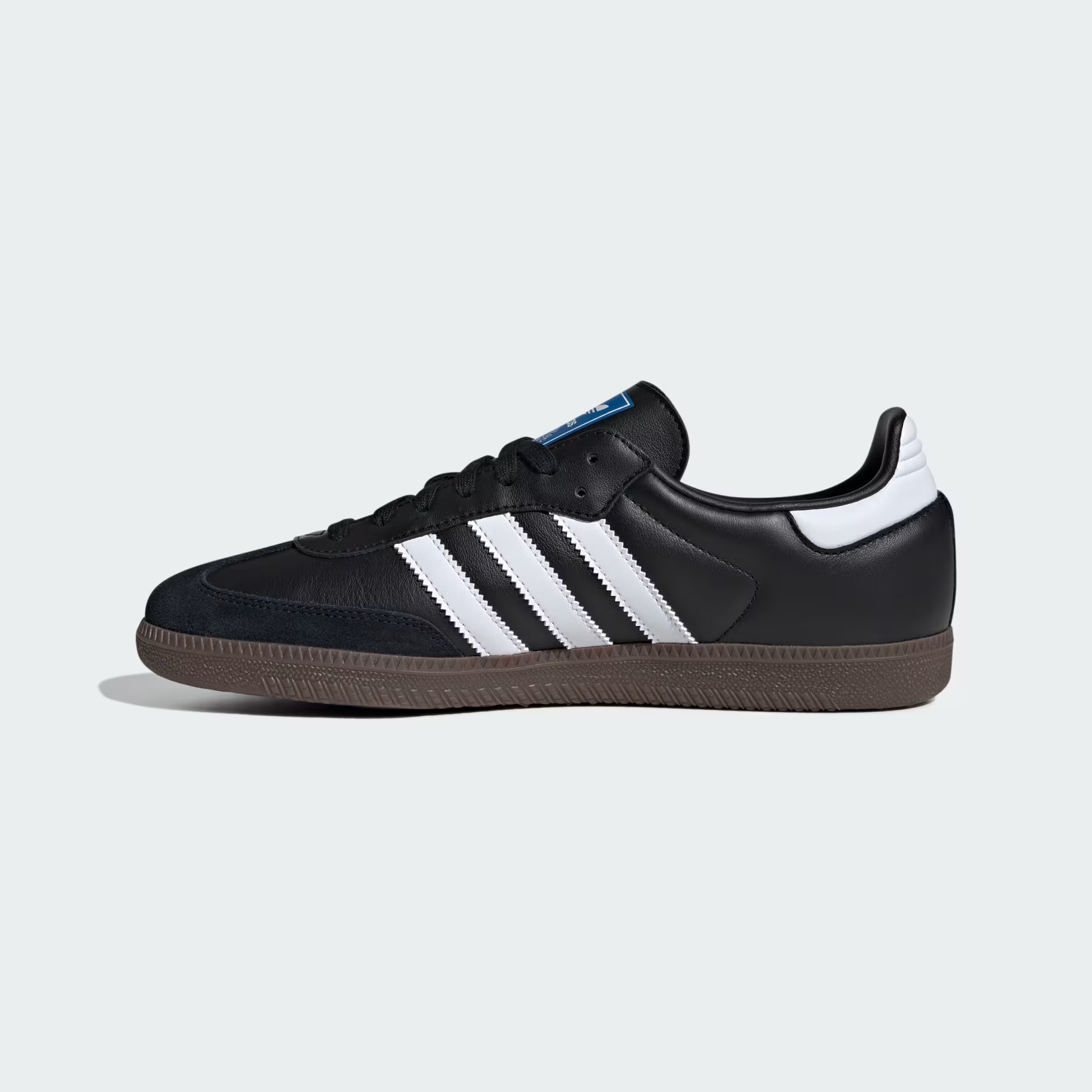 Adidas Samba OG B75807 - Toe Box & Forefoot Top-Down Close-up showing Black Suede Toe Cap Texture, Core Black Full-Grain Leather Upper, Black Flat Laces, Cloud White Three Stripes Base, Blue Adidas Originals Tongue Label with Trefoil Logo & Gum Rubber Outsole Edge