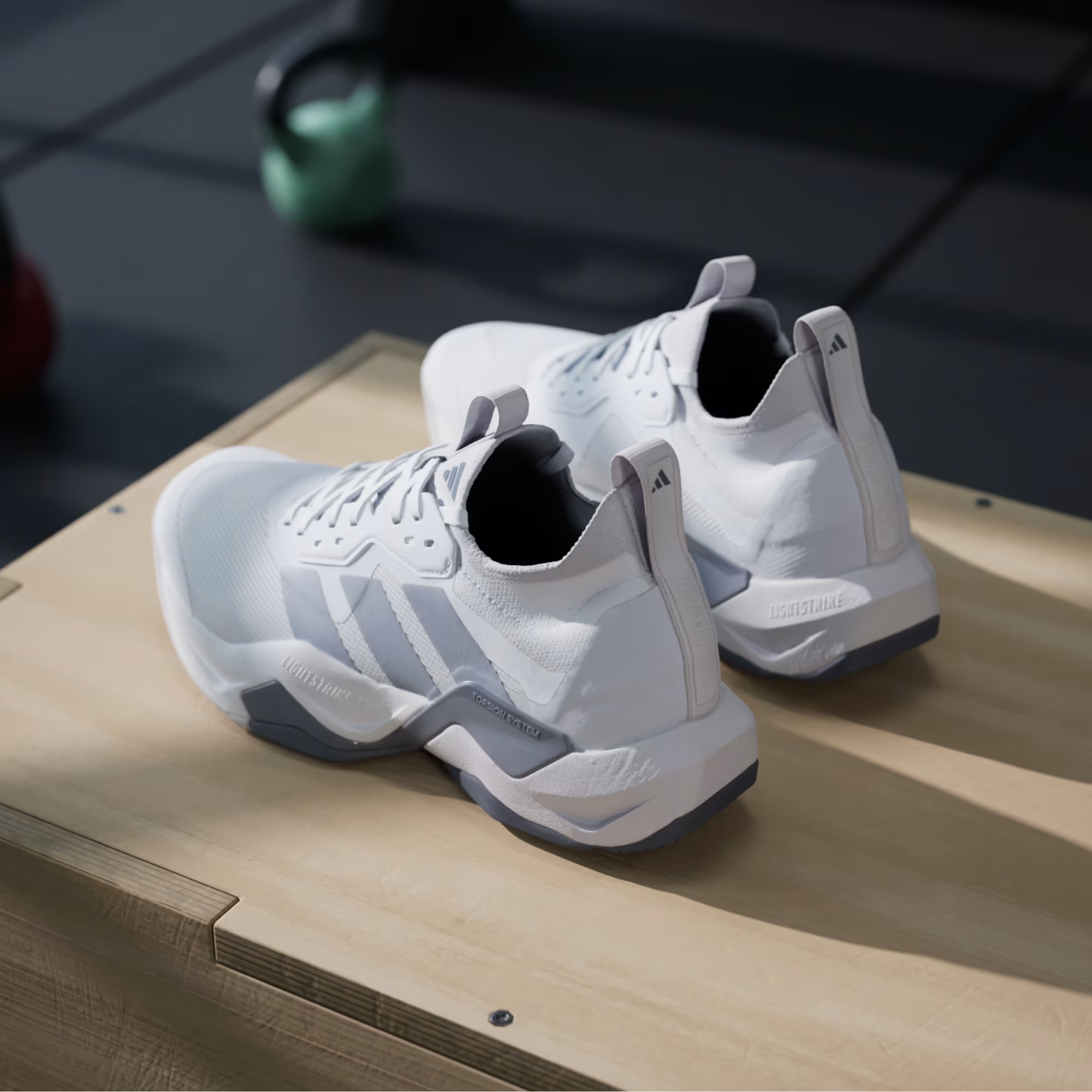 Adidas Rapidmove ADV 2 JI4196 - Overhead Pair Shot on Gym Mat showing Outsole Traction Pattern with Grey & White Rubber Pods, Halo Silver Three Stripes & Lightstrike Pro Midsole