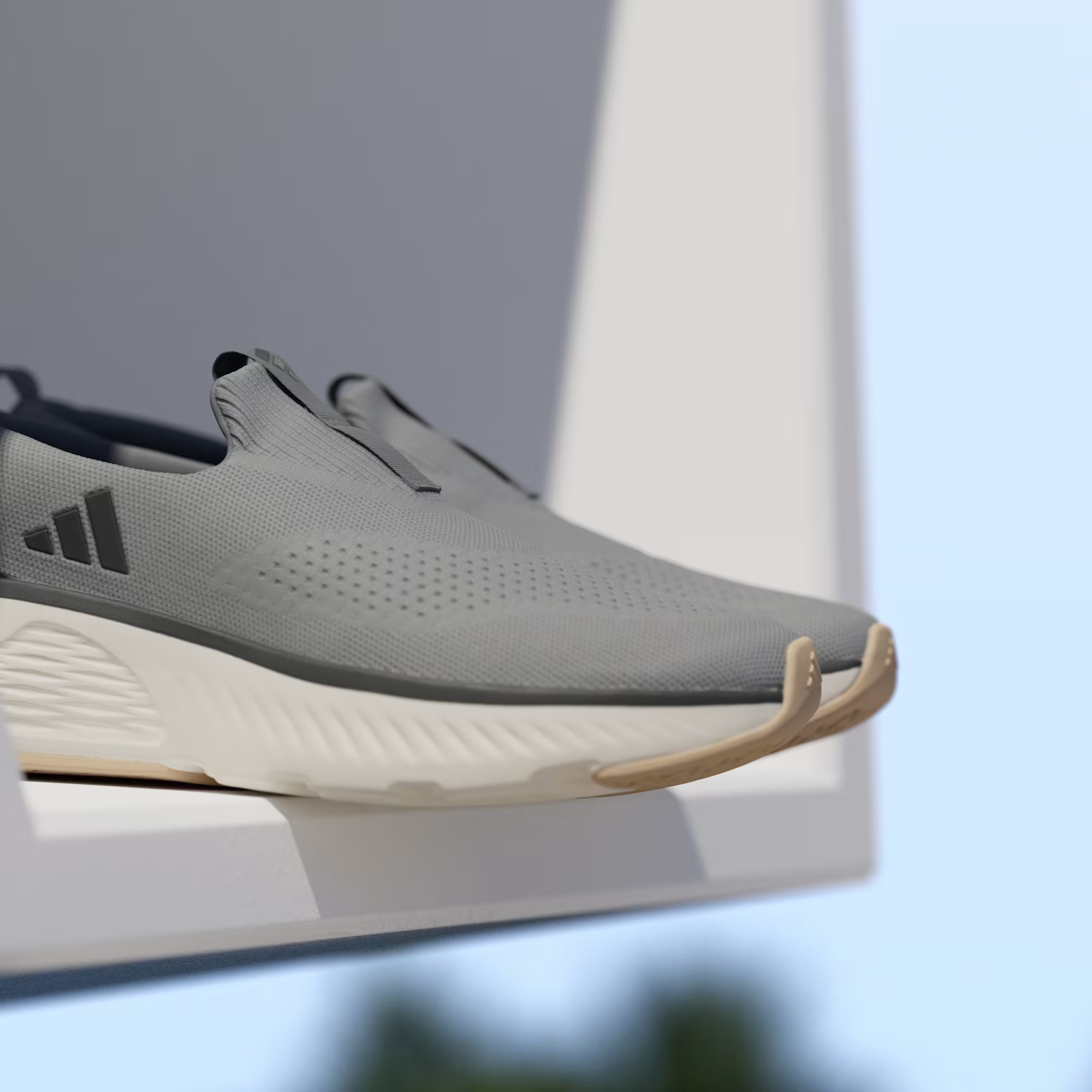 Adidas Cloudfoam Go Lounger ID4021 - Forefoot Close-up on White Ledge showing Grey Three Knit Mesh Upper, Dark Grey Three Stripes, Perforated Toe Box Detail & Off White Midsole with Gum Outsole Tip