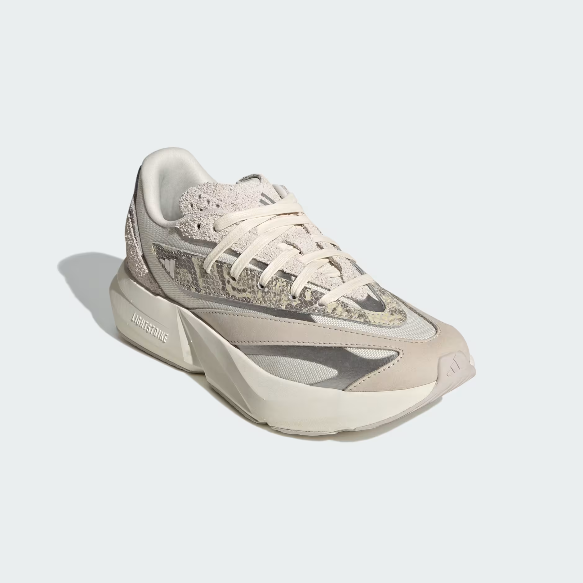 Adidas Lightblaze JQ7221 - Rear 3/4 Shot on White Background showing Off White Textured Upper, Silver Metallic Three Stripes Badge on Lateral, Crinkled Suede Heel Counter, Grey One Overlays & Chunky Off White Lightstrike Midsole