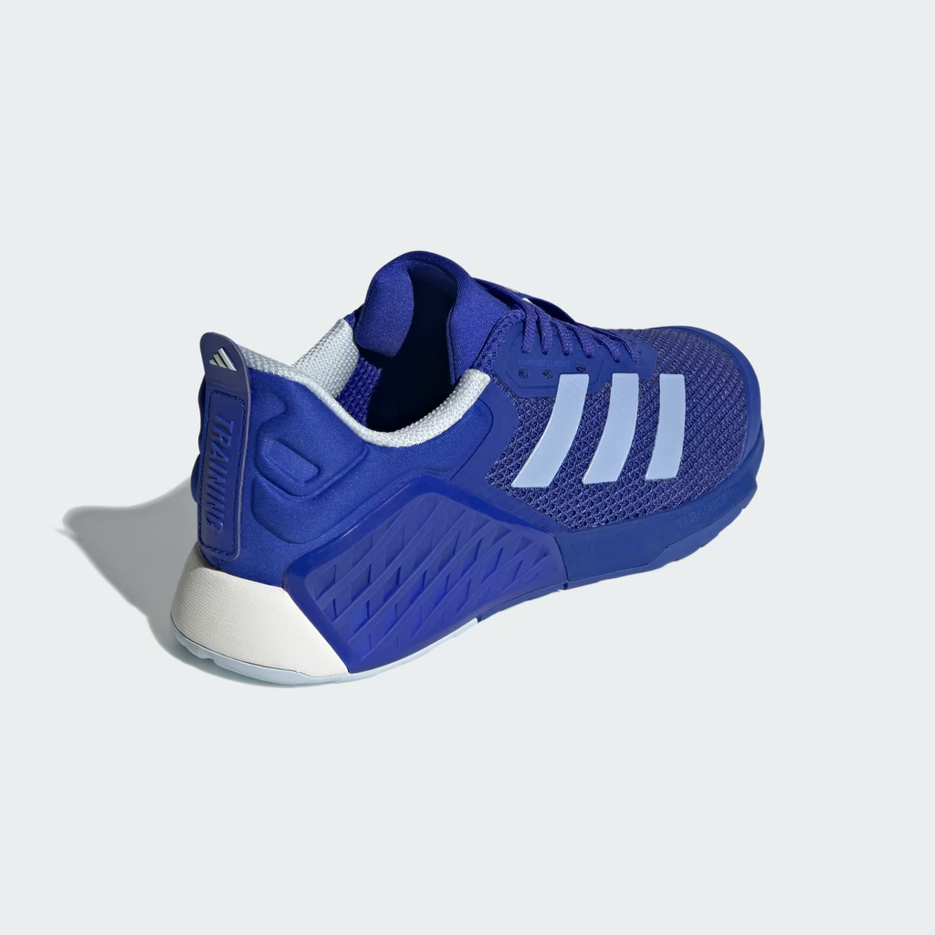 Adidas Dropset 3 ID8636 - Outsole Torsion System Close-up showing Lucid Blue Rubber Outsole with Diagonal Tread Pattern, Torsion System Bridge with Raised TORSION SYSTEM Text Badge, Open Mesh Window Revealing White Midsole & Chalk White Heel Outsole Section
