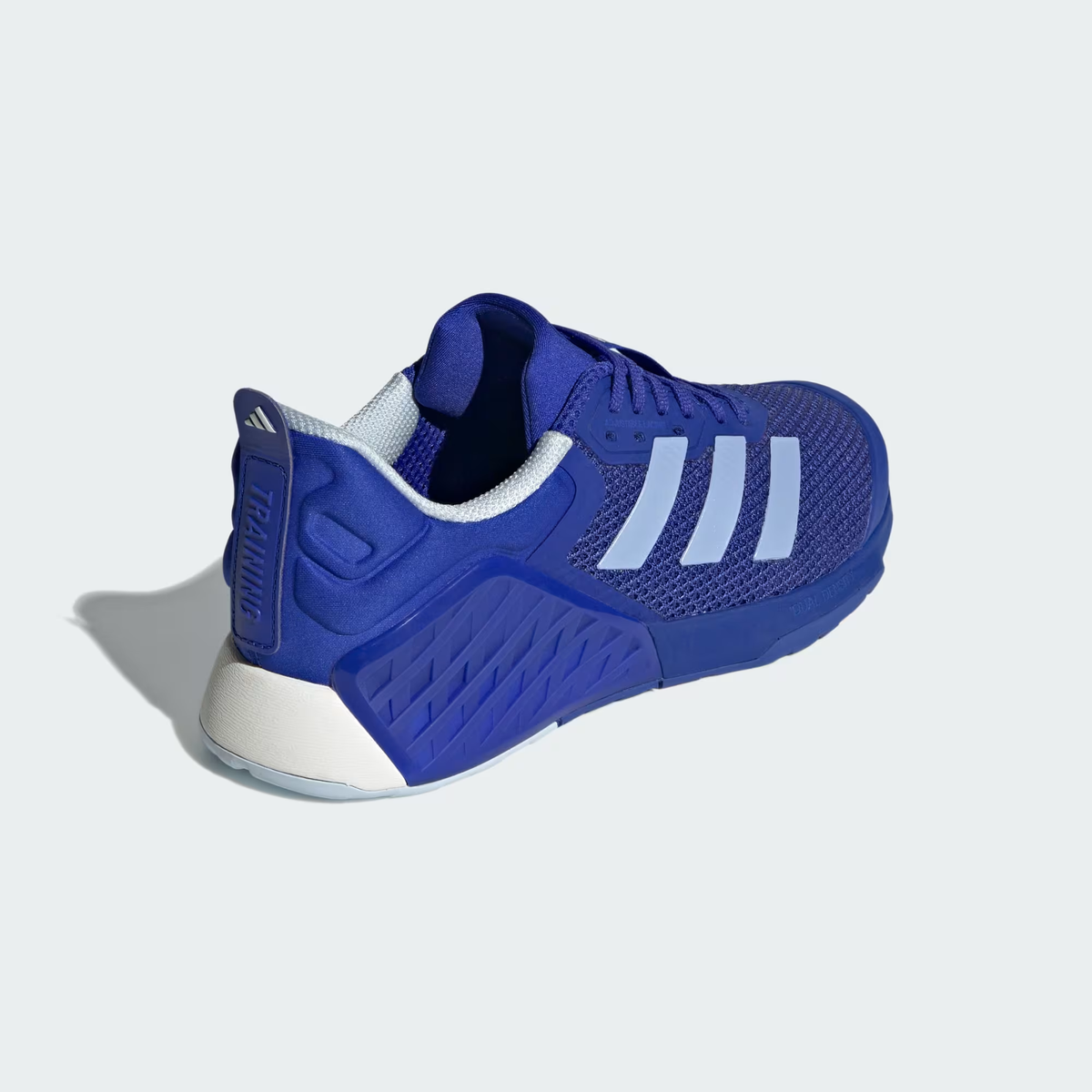 Adidas Dropset 3 ID8636 - Outsole Torsion System Close-up showing Lucid Blue Rubber Outsole with Diagonal Tread Pattern, Torsion System Bridge with Raised TORSION SYSTEM Text Badge, Open Mesh Window Revealing White Midsole & Chalk White Heel Outsole Section
