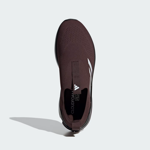 Adidas Cloudfoam Walk Sock ID4063 - Full Rubber Outsole Top-Down on Light Grey Background in Black/Shadow Brown showing Segmented Multi-Zone Traction Pads with Honeycomb Texture, X-shaped Flex Groove Channels, Shadow Brown Heel Traction Pad & Cloudfoam Walk Embossed on Heel