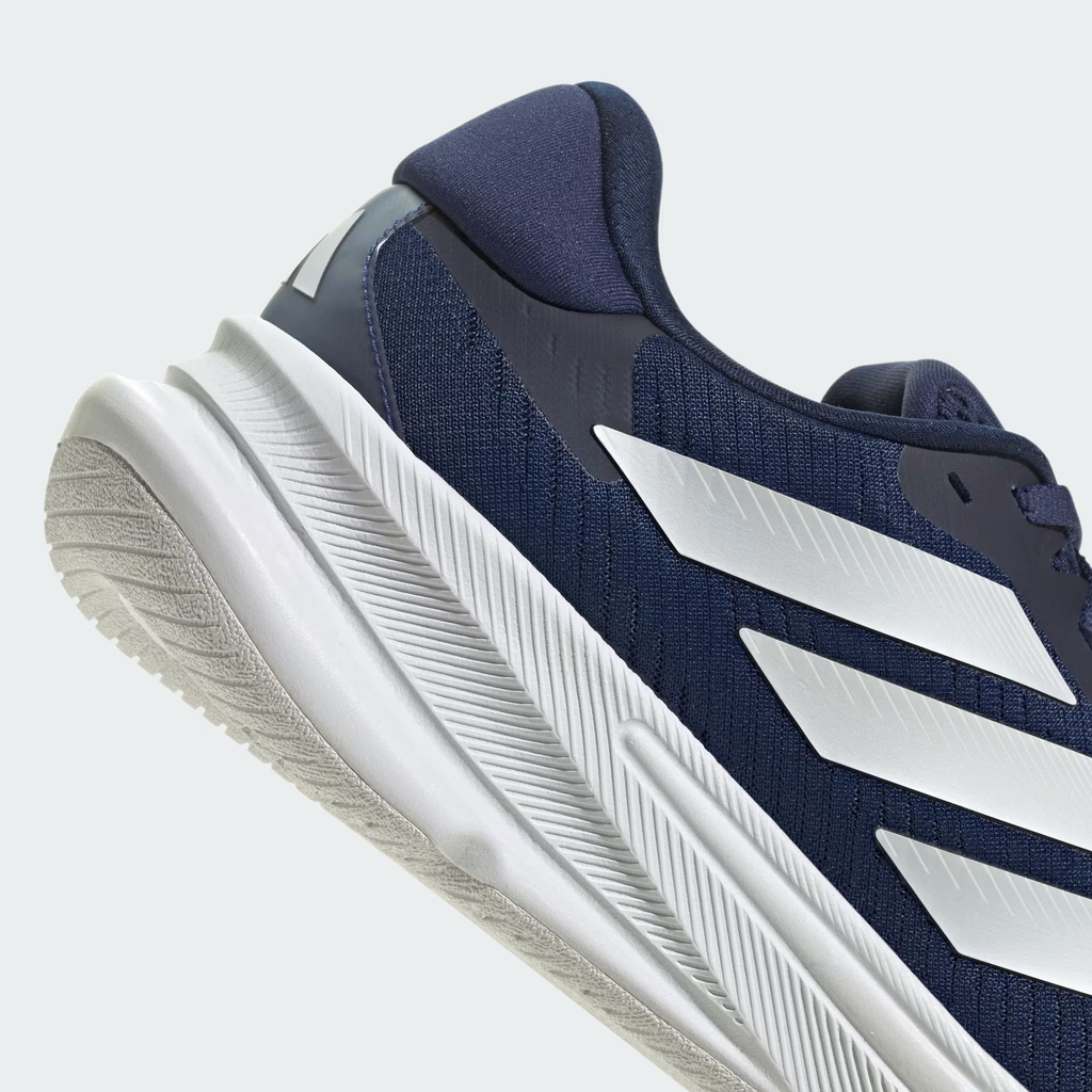 Adidas Supernova Ease JH8560 - Outsole Close-up on Light Grey Background showing White Rubber Traction Pattern with 4-Channel Flex Grooves, Herringbone Texture & Waist Cutout