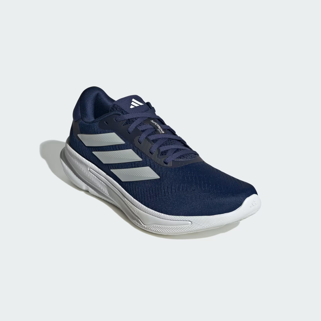 Adidas Supernova Ease JH8560 - Rear 3/4 Shot on Light Grey Background showing Dark Blue Engineered Mesh Upper, Zero Metallic Three Stripes on Lateral, Dark Blue Padded Collar, Reflective Heel Badge & Chunky White Midsole