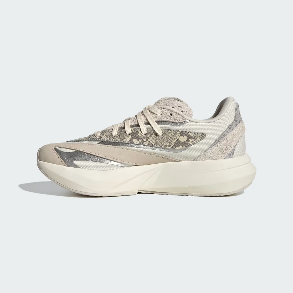 Adidas Lightblaze JQ7221 - Heel & Midsole Close-up showing Crinkled Suede Heel Counter, Grey One Overlays, Silver Metallic Three Stripes Badge on Lateral Window, Off White Laces & Lightstrike Midsole Text