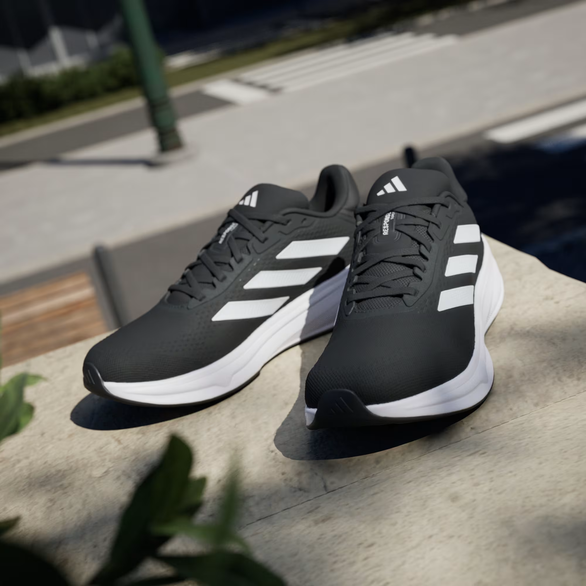 Adidas Response Super JI4308 - Rear Heel Pair Shot on Cobblestone showing Black Heel Counter, White Three Stripes on Lateral & Chunky White Response Midsole Stack