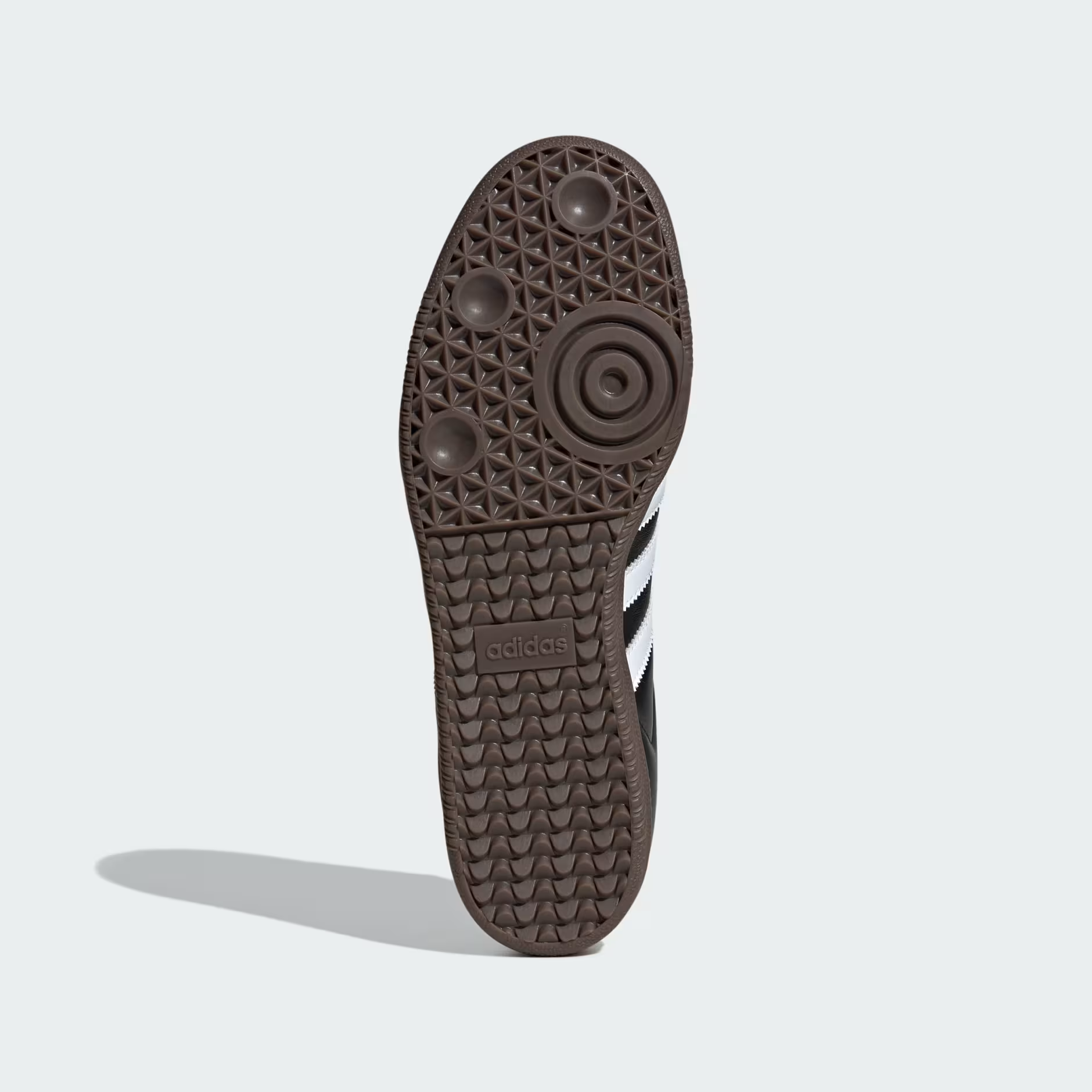 Adidas Samba OG B75807 - Clean Lateral Profile on Light Grey Background showing Full Core Black Leather Silhouette, Cloud White Three Stripes, Black Suede Toe Box, Cloud White Heel Tab, Blue Adidas Trefoil Tongue Badge & Gum Rubber Outsole