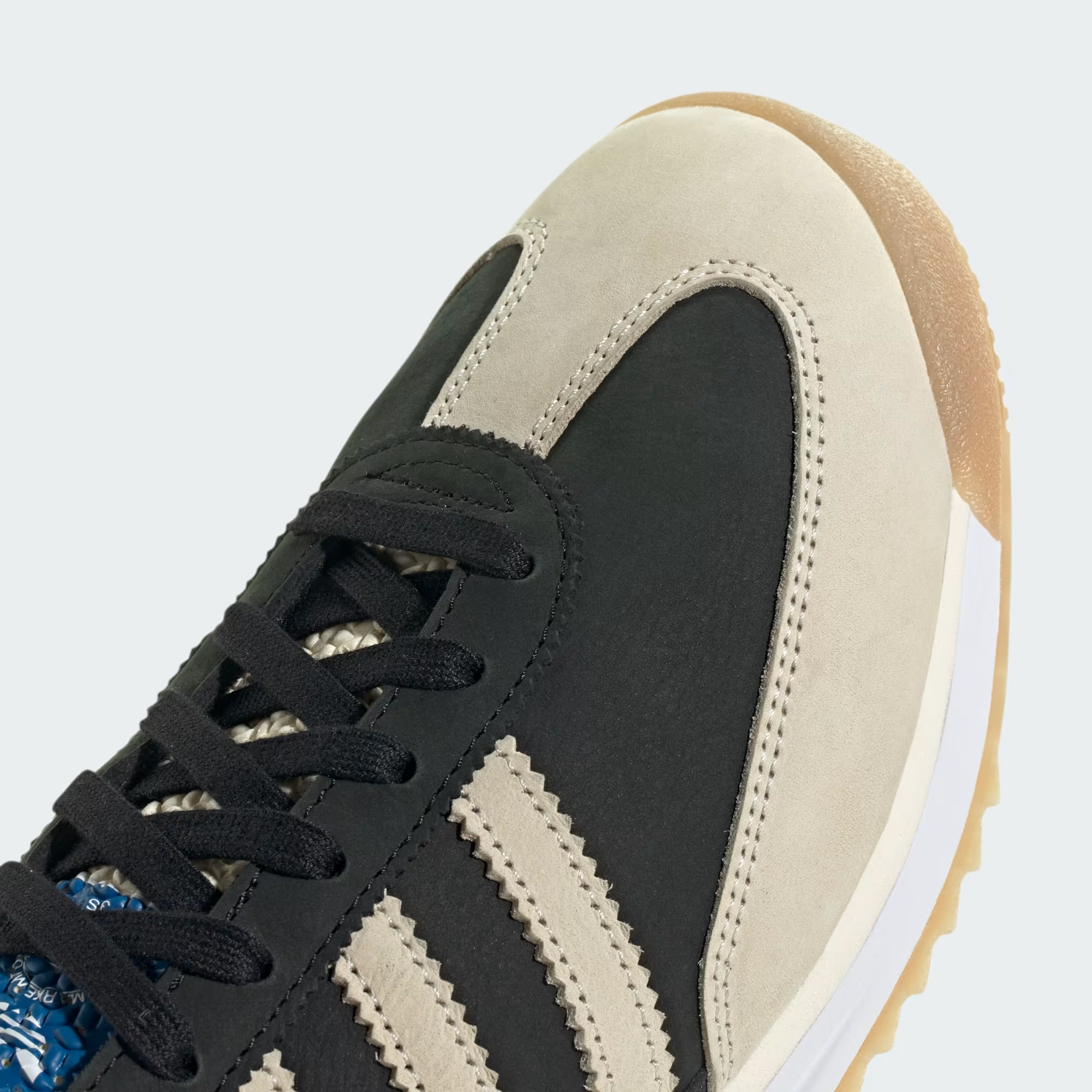 Adidas SL 72 RS JS3994 - Heel Close-up showing Gold Adidas SL 72 Badge on Core Black Nylon, Cream Suede Heel Counter, Cream Three Stripes, White Midsole with Adidas Script & Gum Outsole