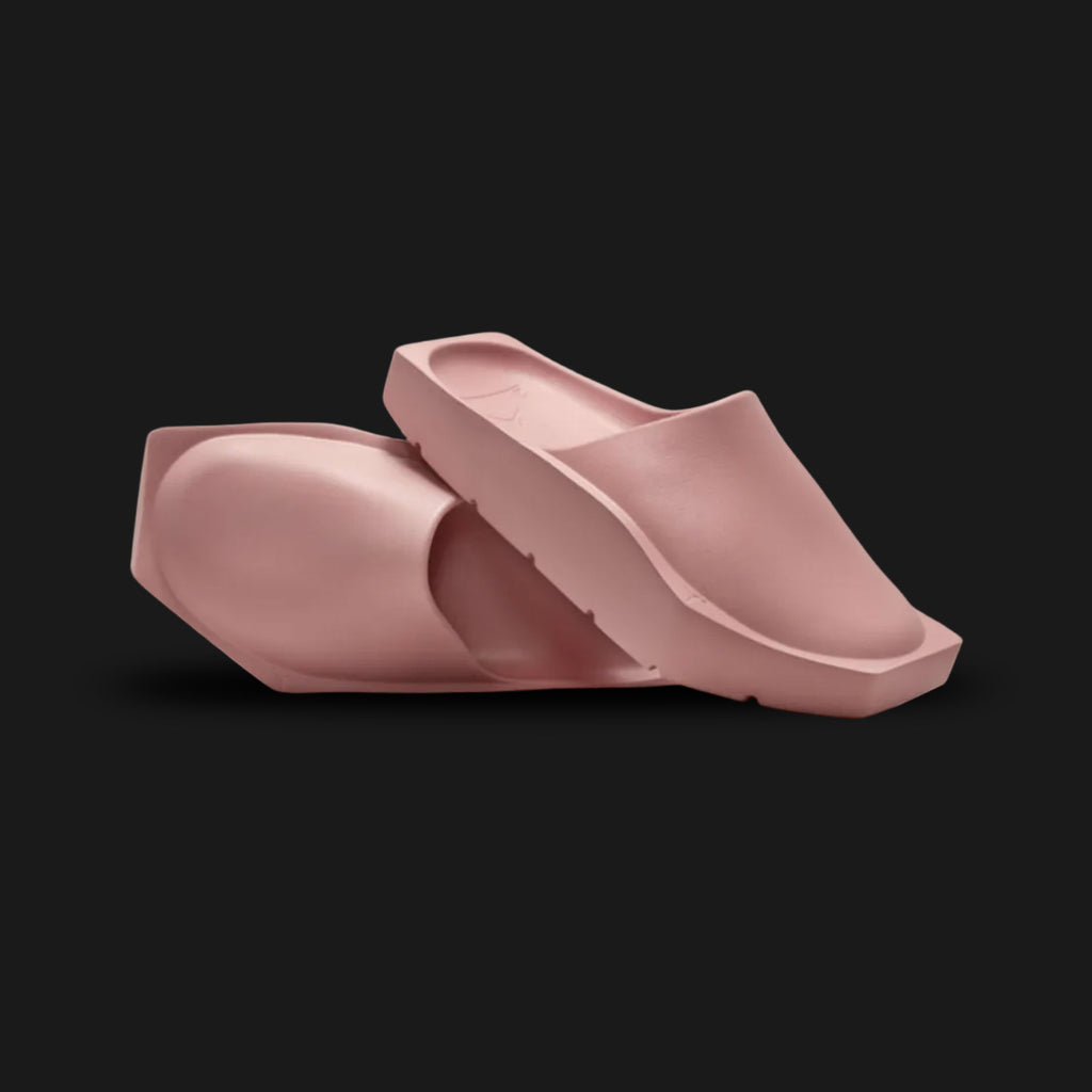 Jordan Hex Mule in Red Stardust (DX6405-600). Features a geometric, hexagonal bio-foam construction in a solid monochrome dusty rose Red Stardust finish. Minimalist design with a squared toe, grooved footbed, and subtle Jumpman branding. Durable traction outsole. Luxuntique offers 100% authentic Jordan slides in Sri Lanka.