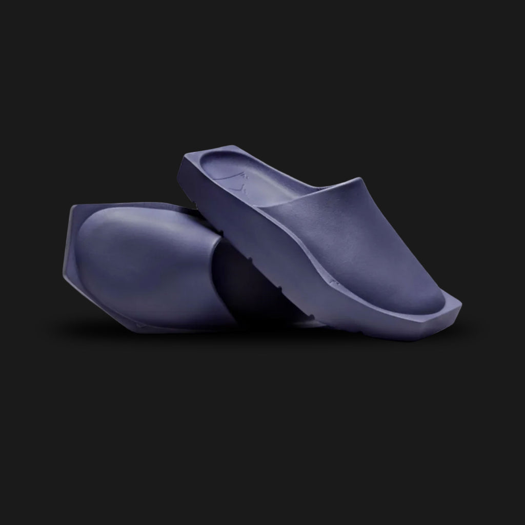 Jordan Hex Mule in Sky J Purple (DX6405-500). Features a geometric, hexagonal bio-foam construction in a solid monochrome Sky J Purple finish. Minimalist design with a squared toe, grooved footbed, and subtle Jumpman branding. Durable traction outsole. Luxuntique offers 100% authentic Jordan slides in Sri Lanka.