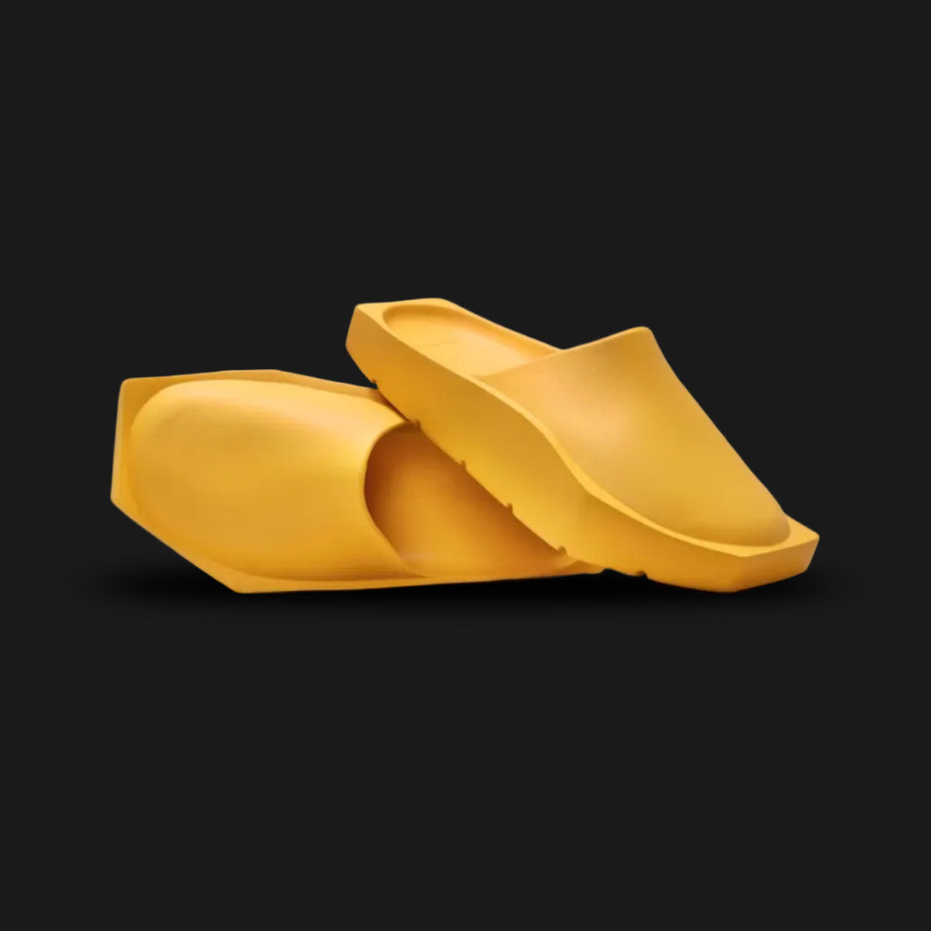 Jordan Hex Mule in Yellow Ochre (DX6405-700). Features a geometric, hexagonal bio-foam construction in a solid monochrome Yellow Ochre finish. Minimalist design with a squared toe, grooved footbed for comfort, and subtle Jumpman branding. Durable traction outsole. Luxuntique offers 100% authentic Jordan slides in Sri Lanka.