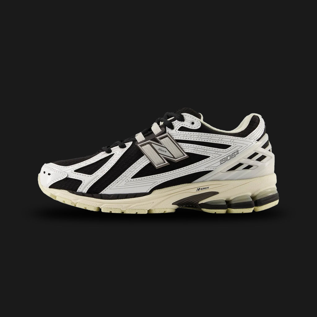 New Balance 1906R shoes in White and Black Metallic (U1906RCI). Features a tech-mesh upper with synthetic overlays, ACTEVA LITE and ABZORB SBS heel cushioning, and an N-ergy outsole for shock absorption. Luxuntique guarantees 100% authentic "New Balance" performance footwear in Sri Lanka.