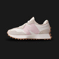 New Balance 327 women's sneakers in Moonbeam with Stone Pink (WS327AL). Features a retro-inspired lifestyle silhouette that modernizes classic 1970s running shoes. Crafted with a premium suede and breathable mesh upper in a neutral Moonbeam cream base, highlighted by an oversized, asymmetrical leather 'N' logo in soft Stone Pink. Includes a comfortable flared foam midsole and a distinctive lugged rubber outsole that wraps around the heel for iconic heritage style and everyday comfort. Luxuntique guarantees 