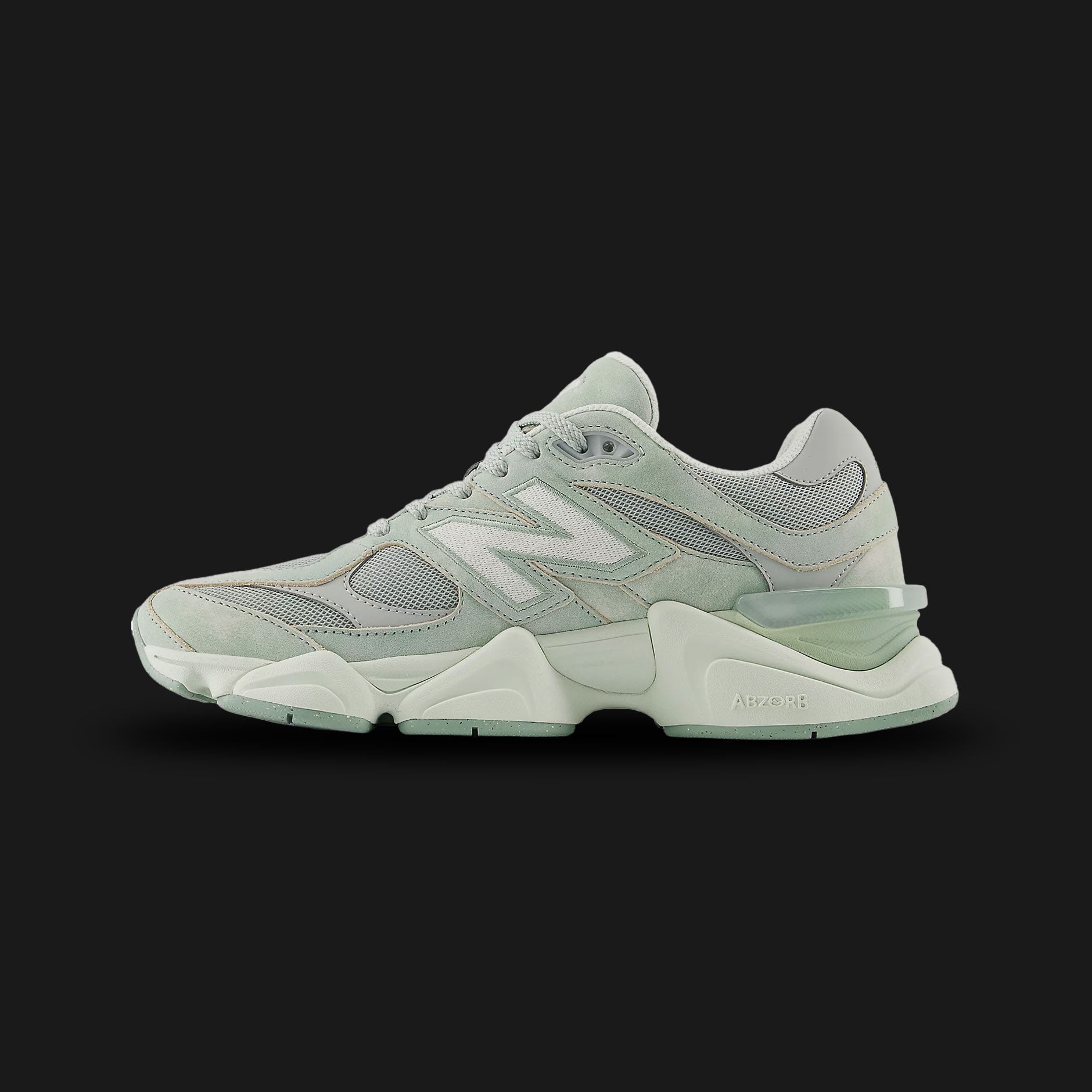 New Balance 9060 sneakers in Mosaic Green with Sea Salt (U90608Z4). Features a futuristic, chunky silhouette reimagined from classic 99X models, showcasing a premium suede and breathable mesh upper in vibrant Mosaic Green with elegant Sea Salt overlays. Includes a sculpted dual-density ABZORB and SBS cushioned midsole, a translucent heel clip, and a unique diamond outsole pattern for superior lifestyle comfort and bold street style. Luxuntique guarantees 100% authentic New Balance footwear in Sri Lanka.
