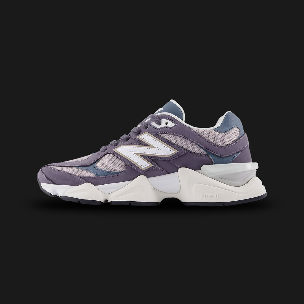 New Balance 9060 sneakers in Neptune Grey with Shadow Blue (U9060528). Features a futuristic, chunky silhouette reimagined from classic 99X models, showcasing a premium suede and breathable mesh upper in cool Neptune Grey with sophisticated Shadow Blue overlays. Equipped with a sculpted dual-density ABZORB and SBS cushioned midsole, a translucent CR heel clip, and a unique diamond outsole pattern for everyday lifestyle comfort and bold street style. Luxuntique guarantees 100% authentic New Balance footwear 