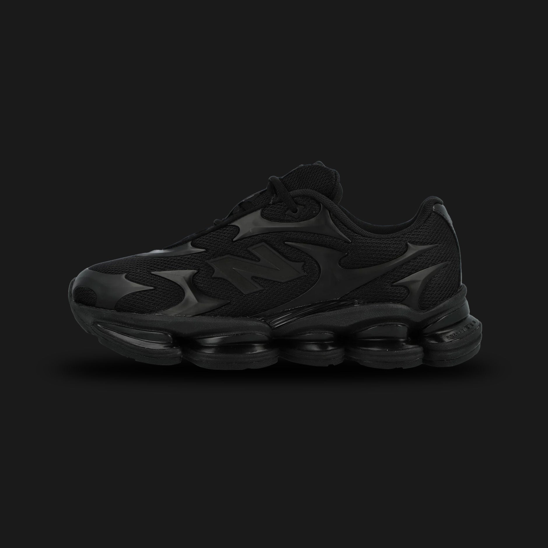 New Balance ABZORB 2000 shoes in Black Metallic (U200078C). Features a minimalist mesh upper with futuristic overlay patterns, a segmented full-length ABZORB sole unit, and ABZORB SBS heel pods for maximum stability. Luxuntique guarantees 100% authentic "New Balance" footwear in Sri Lanka.