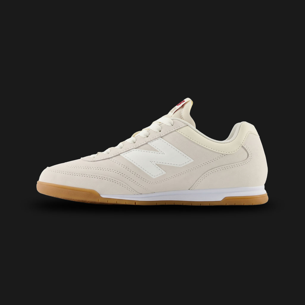 New Balance RC42 shoes in Linen and Sea Salt (URC42EA). Features a premium suede and leather upper, low-profile retro 70s wedge silhouette, stitched N logo, and a durable rubber outsole. Luxuntique guarantees 100% authentic footwear.