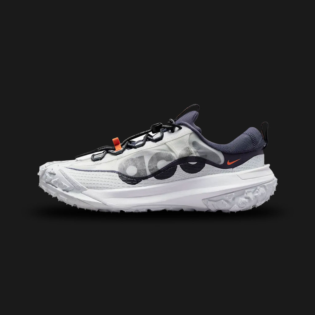 Nike ACG Mountain Fly 2 Low in Gridiron, Summit White, and Black (Design Code: DV7903-001). Featuring an oversized lugged rubber outsole for trail traction, a semi-gusseted tongue for debris protection, and durable ACG branding. Luxuntique offers 100% authentic Nike outdoor performance footwear at the lowest price in Sri Lanka.