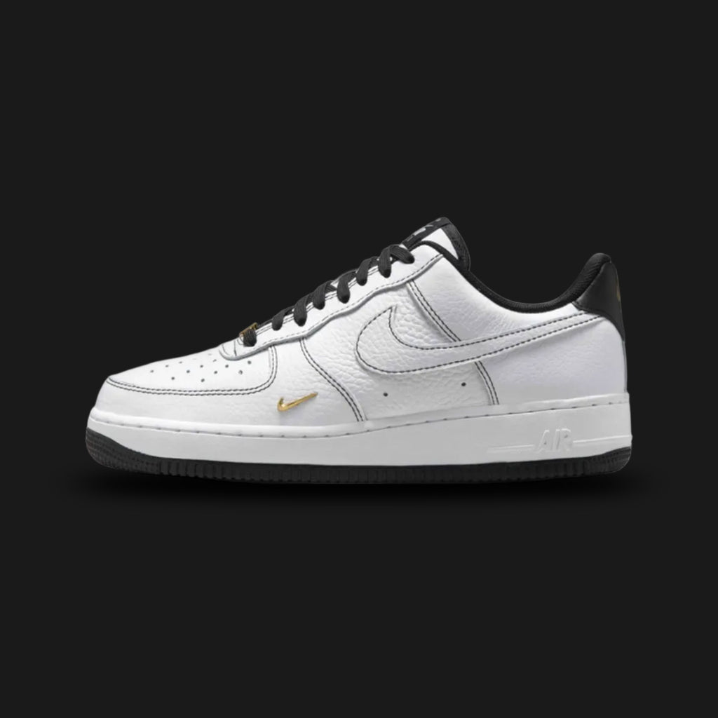 Nike Air Force 1 '07 Mini Jewel in White, Metallic Gold, and Black (IB6543-101). Features a premium crisp white leather upper with a small, raised Metallic Gold jewel Swoosh and black branding accents. Classic chunky AF1 midsole with encapsulated Air cushioning. Luxuntique offers 100% authentic Nike footwear in Sri Lanka.