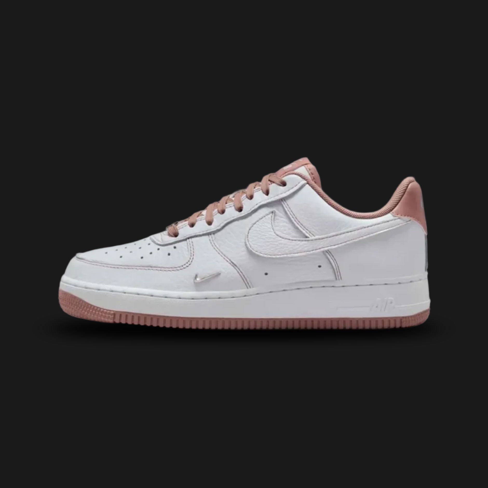 Nike Air Force 1 '07 Mini Jewel in White, Metallic Silver, and Particle Pink (IB6543-100). Features a premium white leather upper with a raised Metallic Silver mini jewel Swoosh and soft Particle Pink accents on the heel tab and tongue. Iconic chunky AF1 midsole. Luxuntique offers 100% authentic Nike footwear in Sri Lanka.