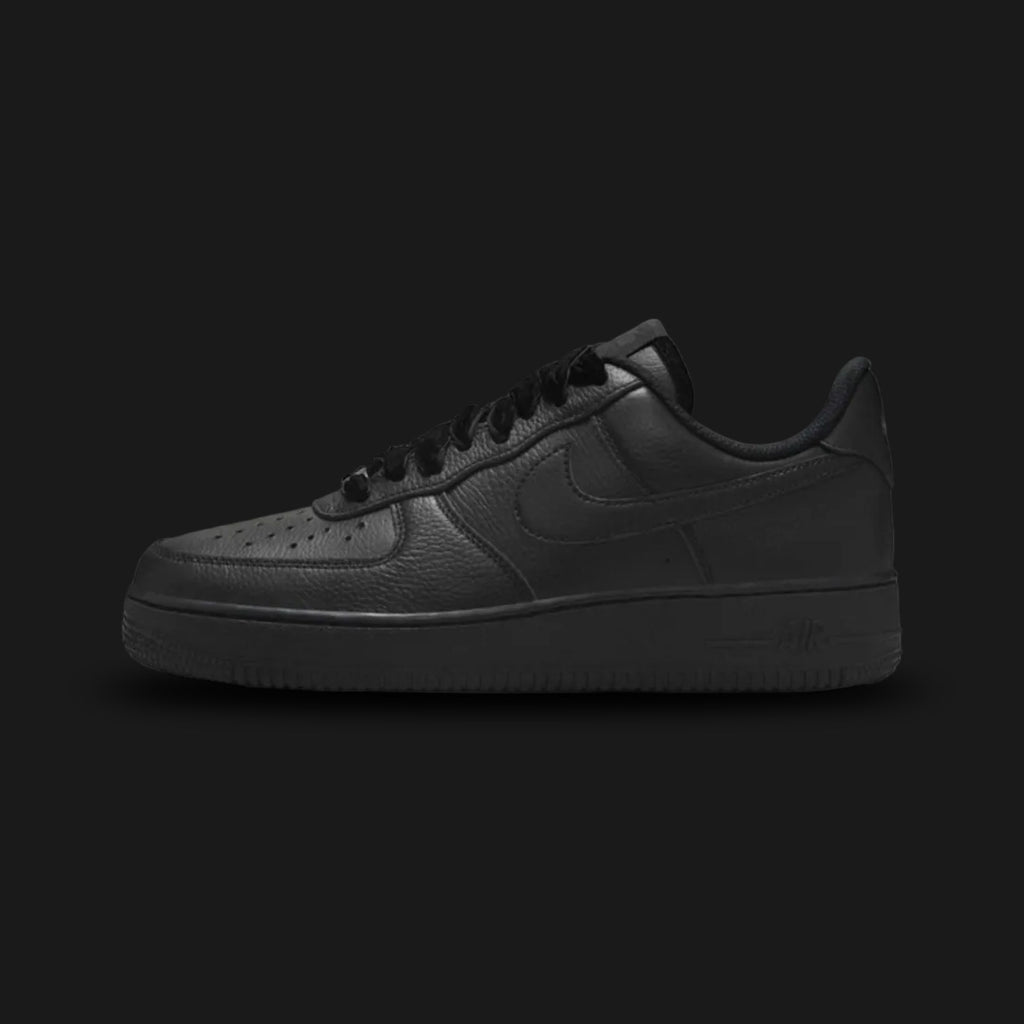 Nike Air Force 1 '07 Vintage lifestyle sneakers in Black, Anthracite, and Metallic Silver (Design Code: HV4403-001). Featuring a premium, stealthy Black leather upper with subtle dark grey Anthracite overlays and vintage-inspired stitching. Accented by a striking, light-catching Metallic Silver Nike Swoosh and heel branding. Anchored by a durable all-black foam midsole housing concealed Air cushioning, resting on a classic rubber pivot-circle outsole. Luxuntique offers 100% authentic Nike footwear at the lo