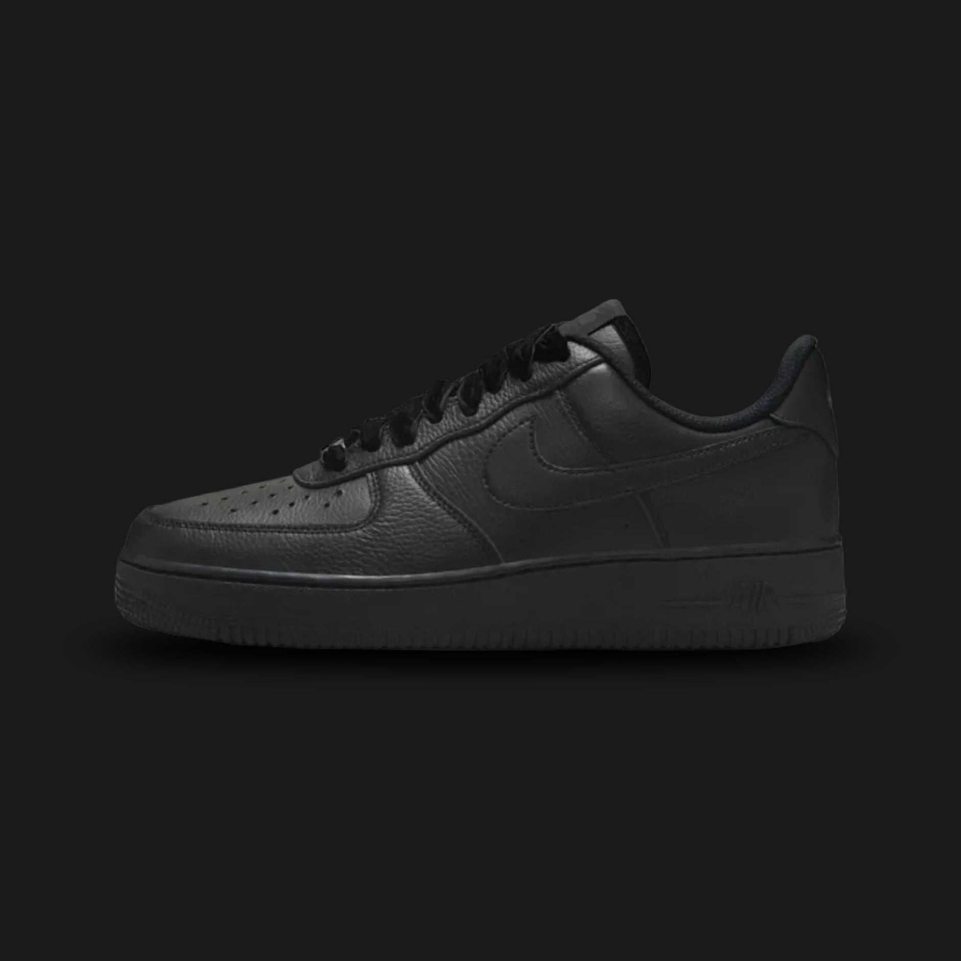 Nike Air Force 1 '07 Vintage lifestyle sneakers in Black, Anthracite, and Metallic Silver (Design Code: HV4403-001). Featuring a premium, stealthy Black leather upper with subtle dark grey Anthracite overlays and vintage-inspired stitching. Accented by a striking, light-catching Metallic Silver Nike Swoosh and heel branding. Anchored by a durable all-black foam midsole housing concealed Air cushioning, resting on a classic rubber pivot-circle outsole. Luxuntique offers 100% authentic Nike footwear at the lo