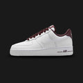 Nike Air Force 1 '07 Vintage lifestyle sneakers in Burgundy Crush, Pale Ivory, Metallic Silver, and White (Design Code: HV4403-600). Featuring a premium structured leather upper that contrasts crisp White with deep, wine-toned Burgundy Crush overlays. Accented by a gleaming Metallic Silver Nike Swoosh and vintage-inspired details. Anchored by a pre-aged Pale Ivory foam midsole housing concealed Air cushioning, resting on a durable rubber outsole. Luxuntique offers 100% authentic Nike footwear at the lowest 