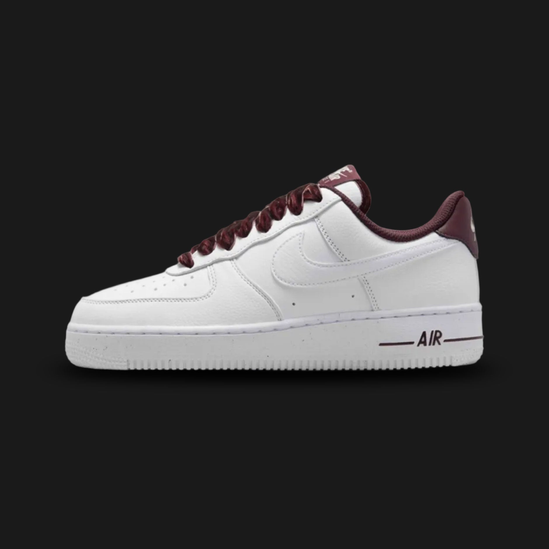 Nike Air Force 1 '07 Vintage lifestyle sneakers in Burgundy Crush, Pale Ivory, Metallic Silver, and White (Design Code: HV4403-600). Featuring a premium structured leather upper that contrasts crisp White with deep, wine-toned Burgundy Crush overlays. Accented by a gleaming Metallic Silver Nike Swoosh and vintage-inspired details. Anchored by a pre-aged Pale Ivory foam midsole housing concealed Air cushioning, resting on a durable rubber outsole. Luxuntique offers 100% authentic Nike footwear at the lowest 