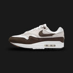 Nike Air Max 1 sneakers in Baroque Brown, Neutral Grey, White, and Black (DZ2628-004). Featuring a rich Baroque Brown suede mudguard and Swoosh over a Neutral Grey and White mesh upper. Anchored by a crisp White midsole with visible Air cushioning and a tri-color outsole. Luxuntique offers 100% authentic Nike footwear in Sri Lanka.