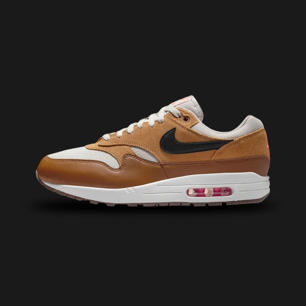Nike Air Max 1 Essential shoes in Light Bone, Flax, British Tan, and Black (Design Code: FZ5808-004). Featuring a premium mixed-material upper with a breathable Light Bone mesh base and rich British Tan suede mudguards. Accented with warm Flax overlays and a sharp Black Swoosh for a sophisticated earth-tone look. Built on a foam midsole with the iconic visible Max Air unit in the heel. Luxuntique offers 100% authentic Nike Air Max sneakers at the lowest price in Sri Lanka.