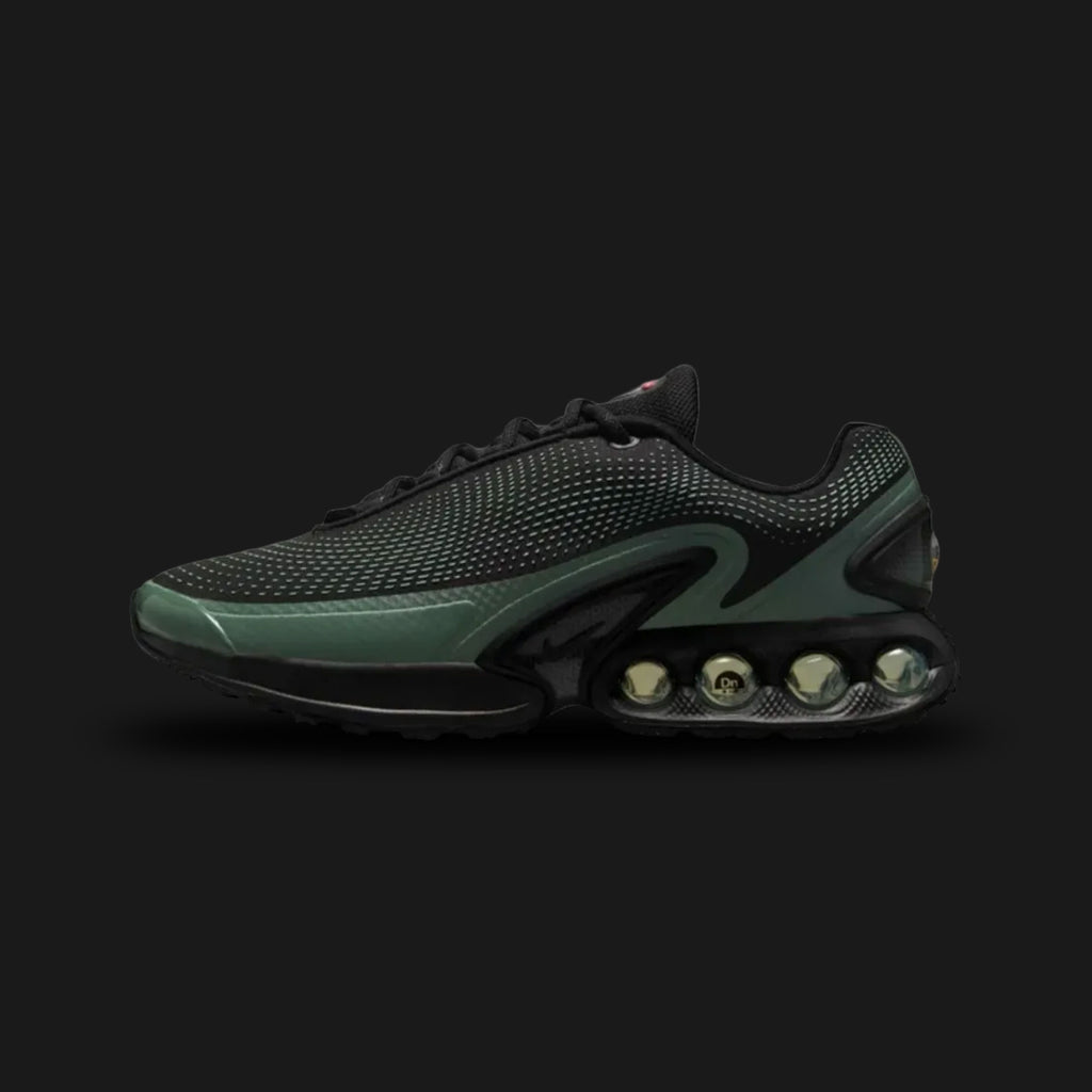 Nike Air Max Dn shoes in Black, Clay Green, and Cannon (Design Code: DV3337-023). Featuring a seamless black mesh upper with a futuristic textured haptic print and sleek synthetic overlays. Accented with tactical Clay Green and Cannon details, and supported by the revolutionary Dynamic Air unit system featuring dual-pressure tubes in the heel for unmatched bounce. Luxuntique offers 100% authentic Nike Air Max sneakers at the lowest price in Sri Lanka.
