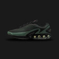 Nike Air Max Dn shoes in Black, Clay Green, and Cannon (Design Code: DV3337-023). Featuring a seamless black mesh upper with a futuristic textured haptic print and sleek synthetic overlays. Accented with tactical Clay Green and Cannon details, and supported by the revolutionary Dynamic Air unit system featuring dual-pressure tubes in the heel for unmatched bounce. Luxuntique offers 100% authentic Nike Air Max sneakers at the lowest price in Sri Lanka.