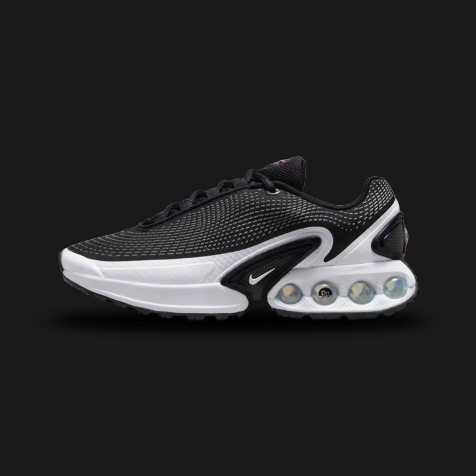 Nike Air Max Dn in Black, Cool Grey, and Pure Platinum (FJ3145-002). Features a Black haptic textured upper and the revolutionary Dynamic Air four-tube system in the heel. Accented by Metallic Silver midfoot shanks. Luxuntique offers 100% authentic Nike footwear in Sri Lanka.